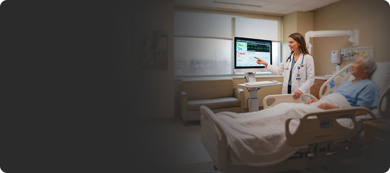 A clinician explaining vitals to a patient in a hospital bed